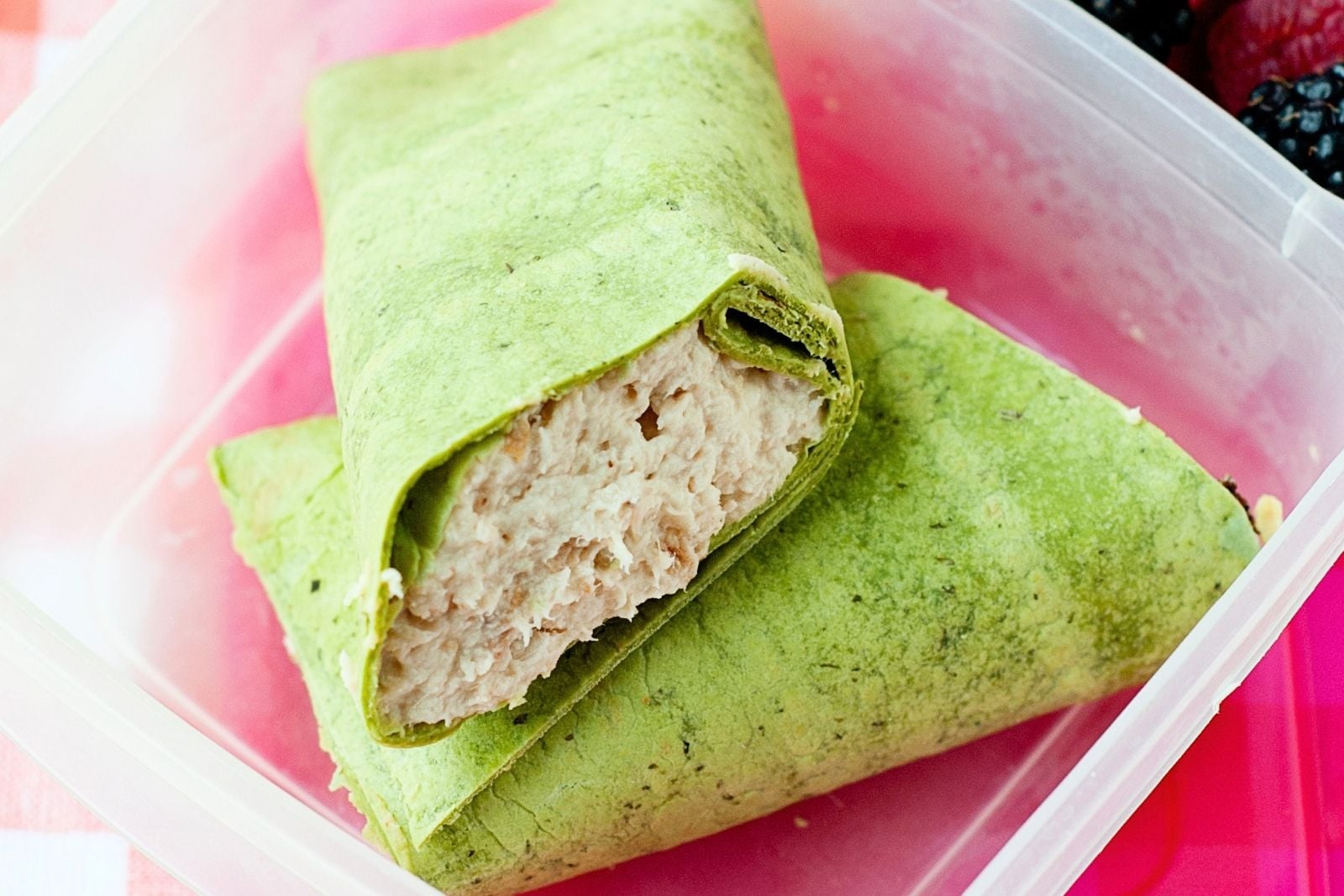 A rotisserie chicken wrap in a lunchbox
