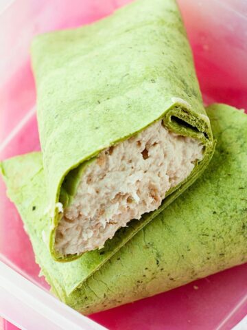 A rotisserie chicken wrap in a lunchbox