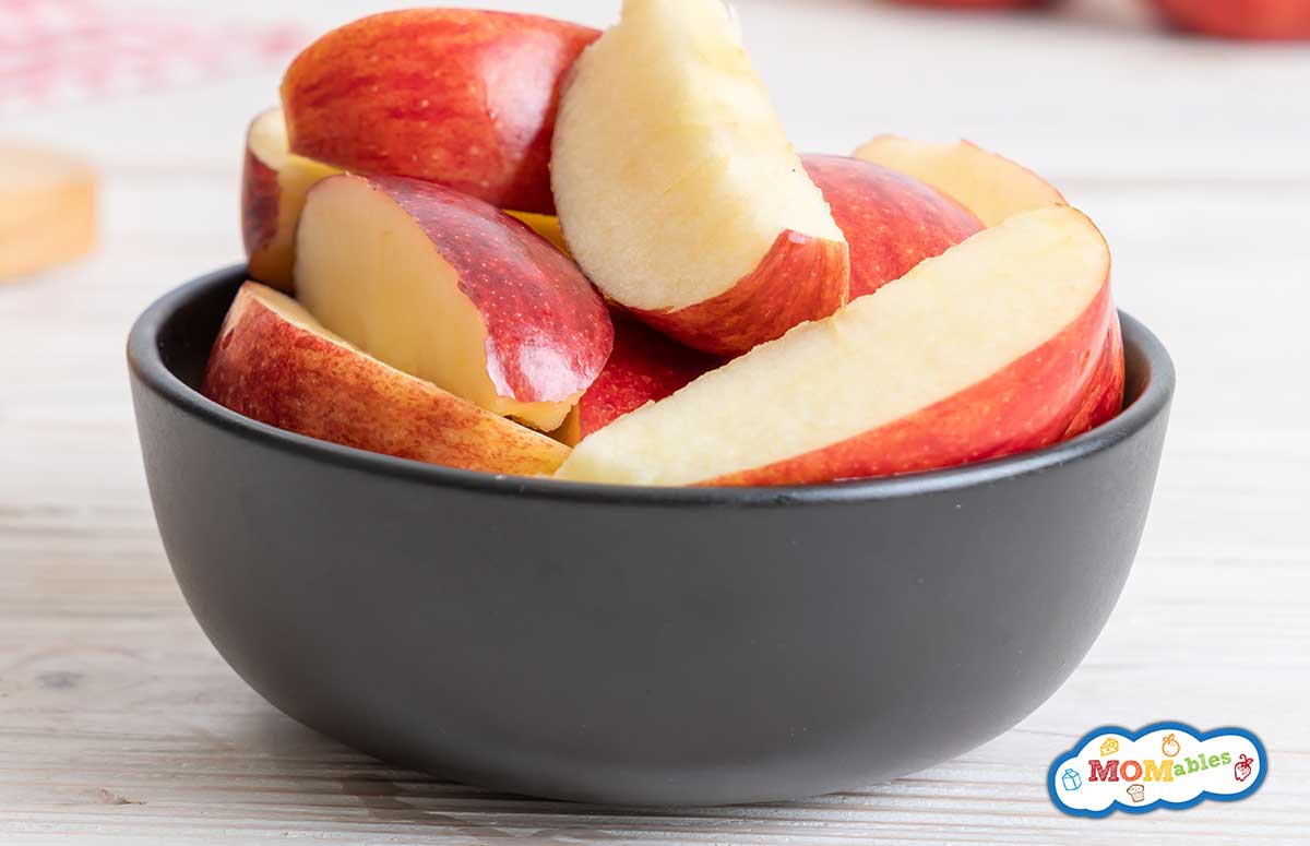 fresh red apples sliced bowl on wood background