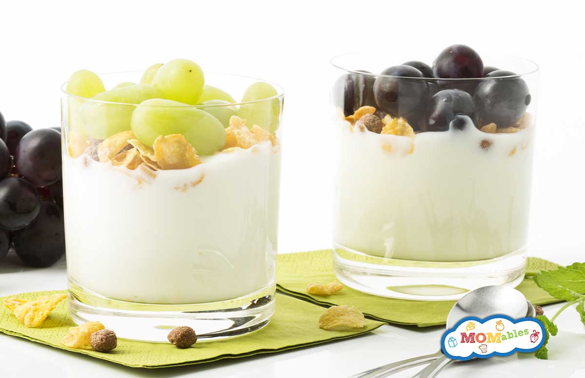 two glasses of grape parfait on paper napkins with grapes on the side