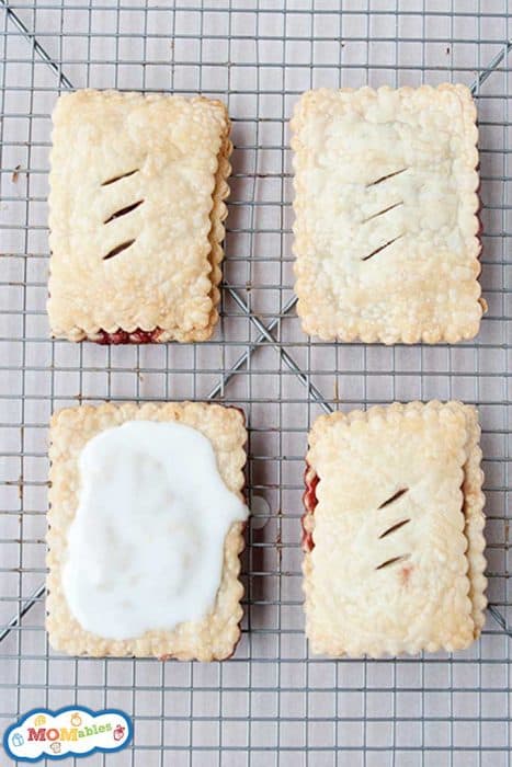 four homemade poptarts on a cooling rack, one of them frosted