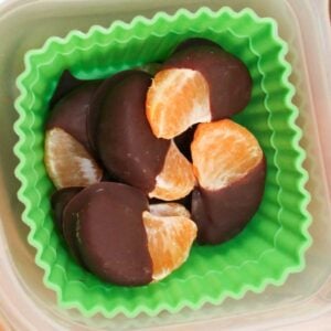 chocolate dipped oranges in a container