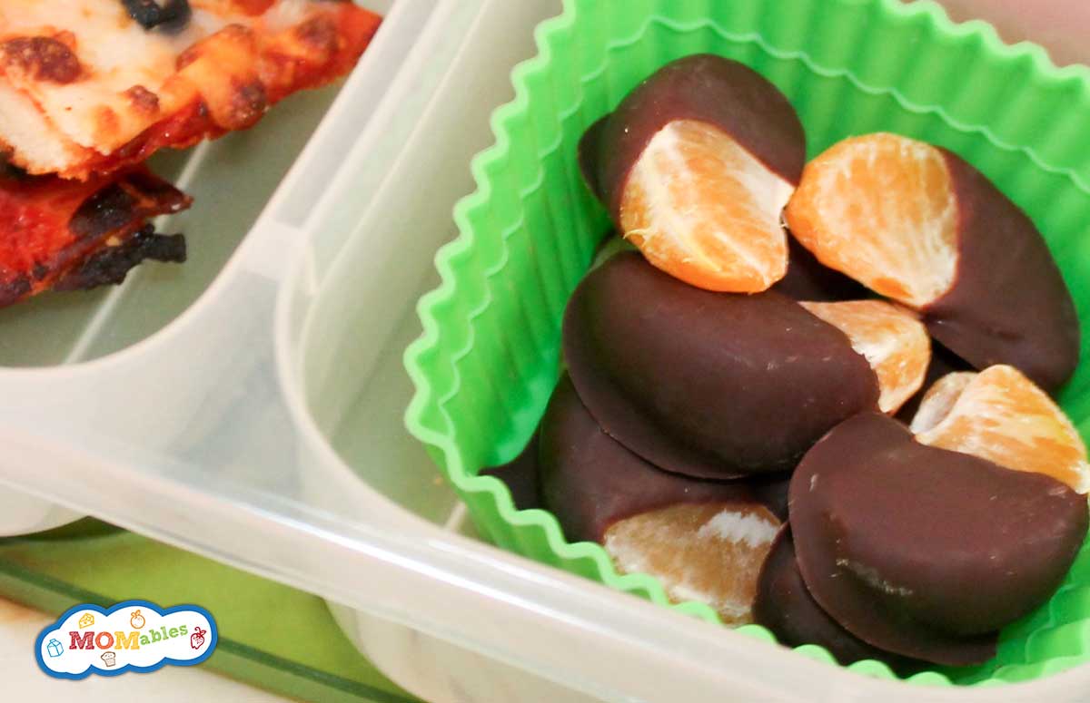 chocolate dipped oranges in a container