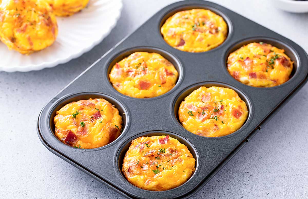 six crustless quiche muffins in a muffin pan