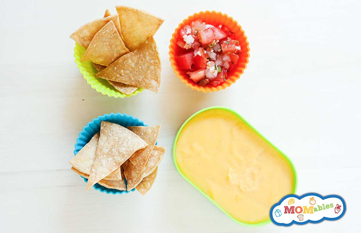 2 cups of tortilla chips served with a cup of pico de gallo and a cup of cheese sauce.