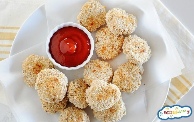 image: a plate full of homemade chicken nuggets on a plate with a small dish of ketchup