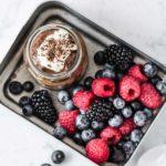 Healthy avocado and banana chocolate pudding in a jar, with fruit