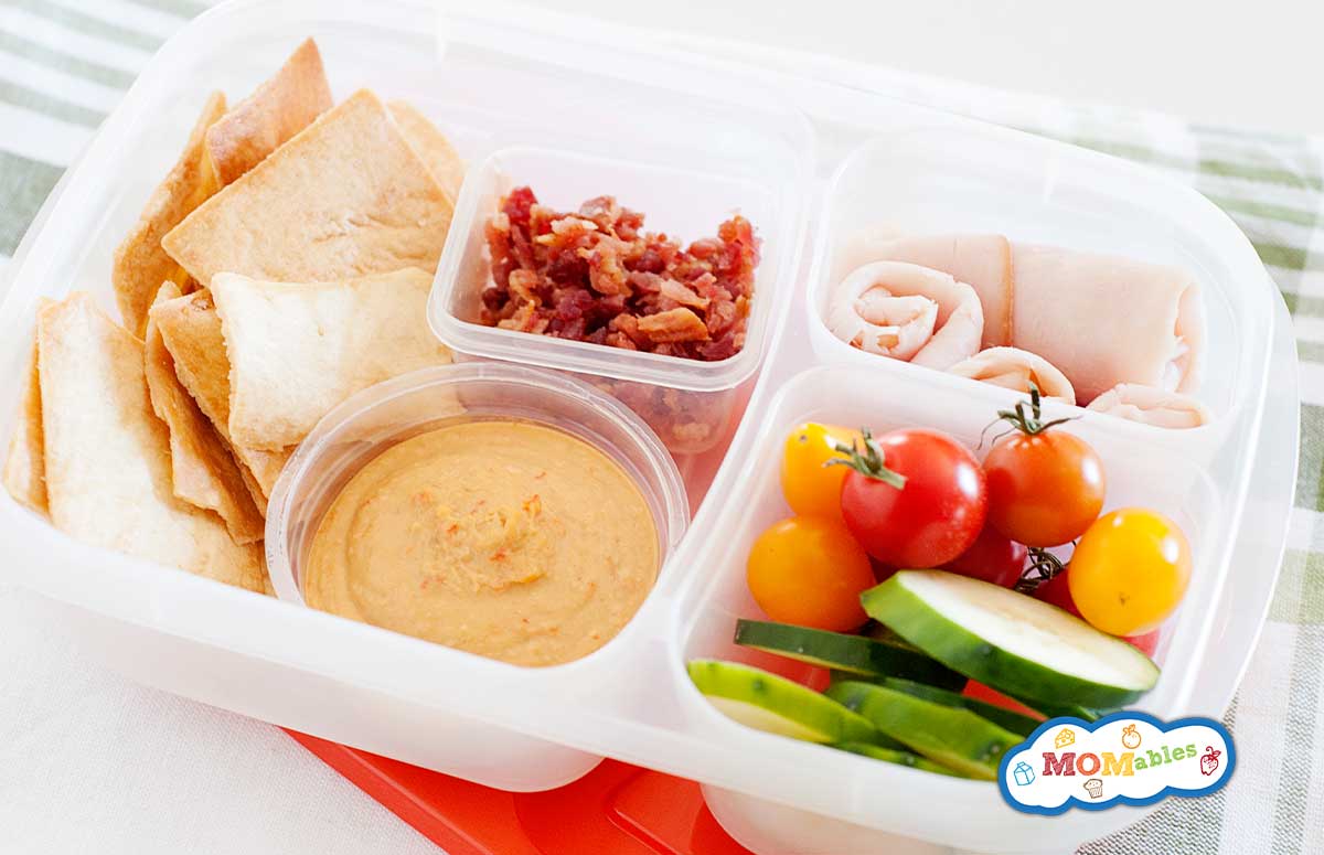 healthy cali lunch box: pita wedges, bacon, ham, cucumber slices, tomatoes and dip