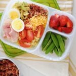 cobb pasta salad in a lunchbox with beans and strawberries on the side