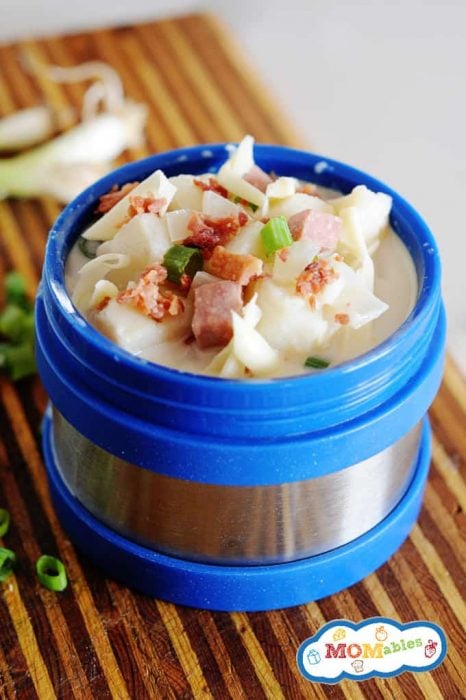 potato soup in a blue open thermos