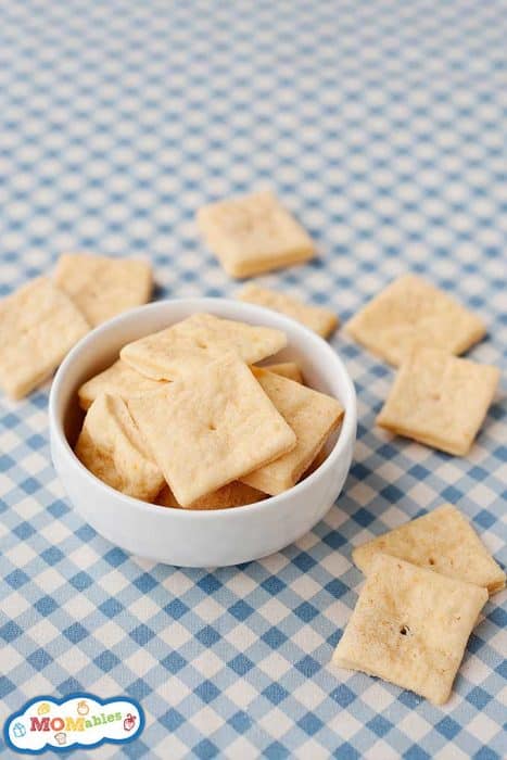 homemade cheese crackers in a small bowl and spilled onto countertop