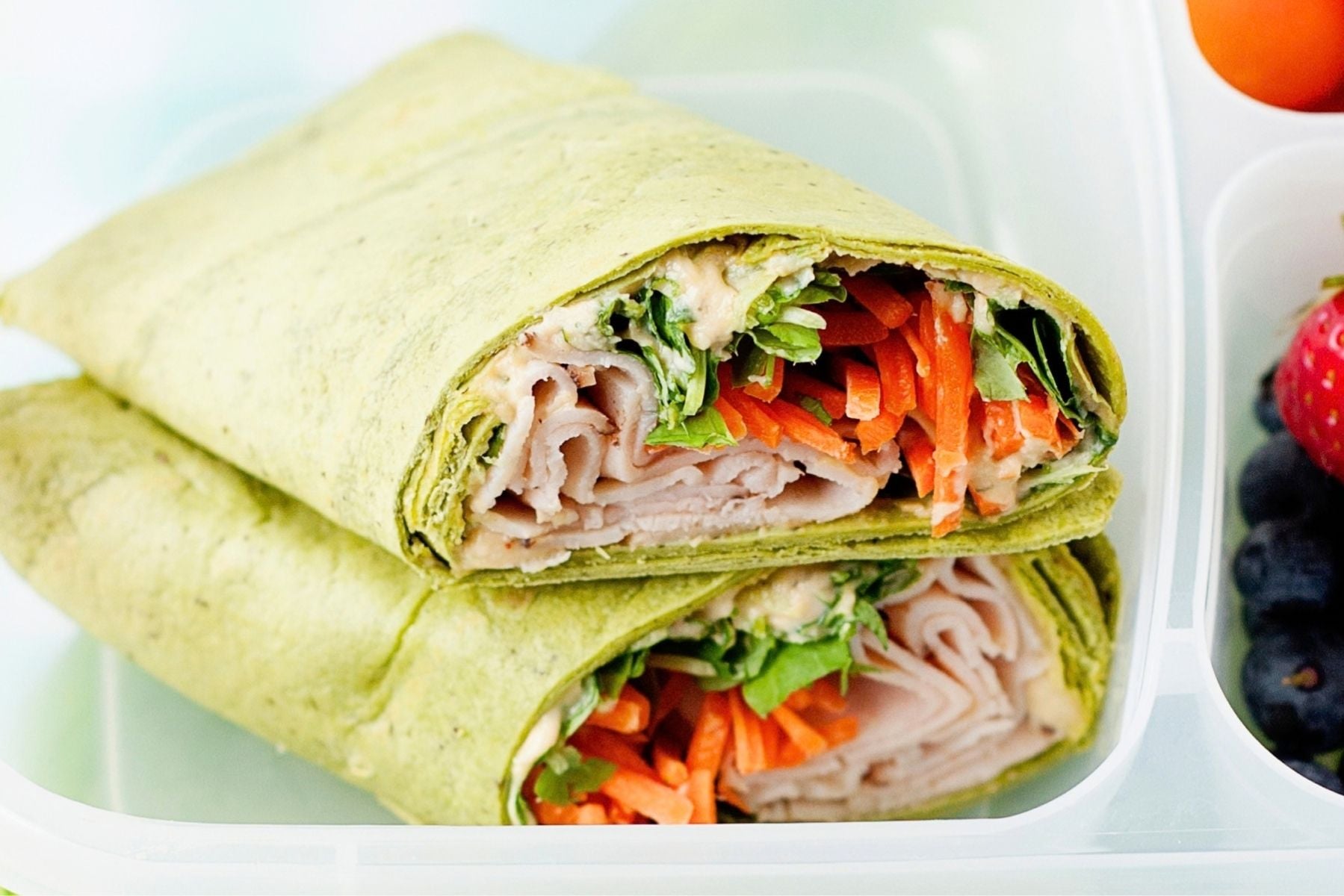turkey hummus wrap halved in a lunch box