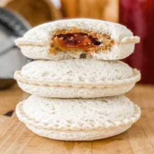 a stack of 3 uncrustables filled with peanut butter and jelly