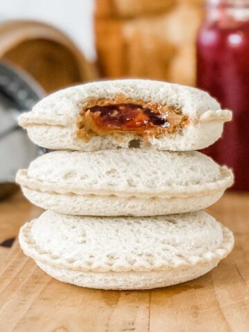 a stack of 3 homemade uncrustables filled with peanut butter and jelly
