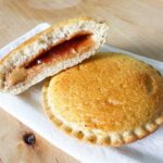 two air fried uncrustables on a plate, one cut in half