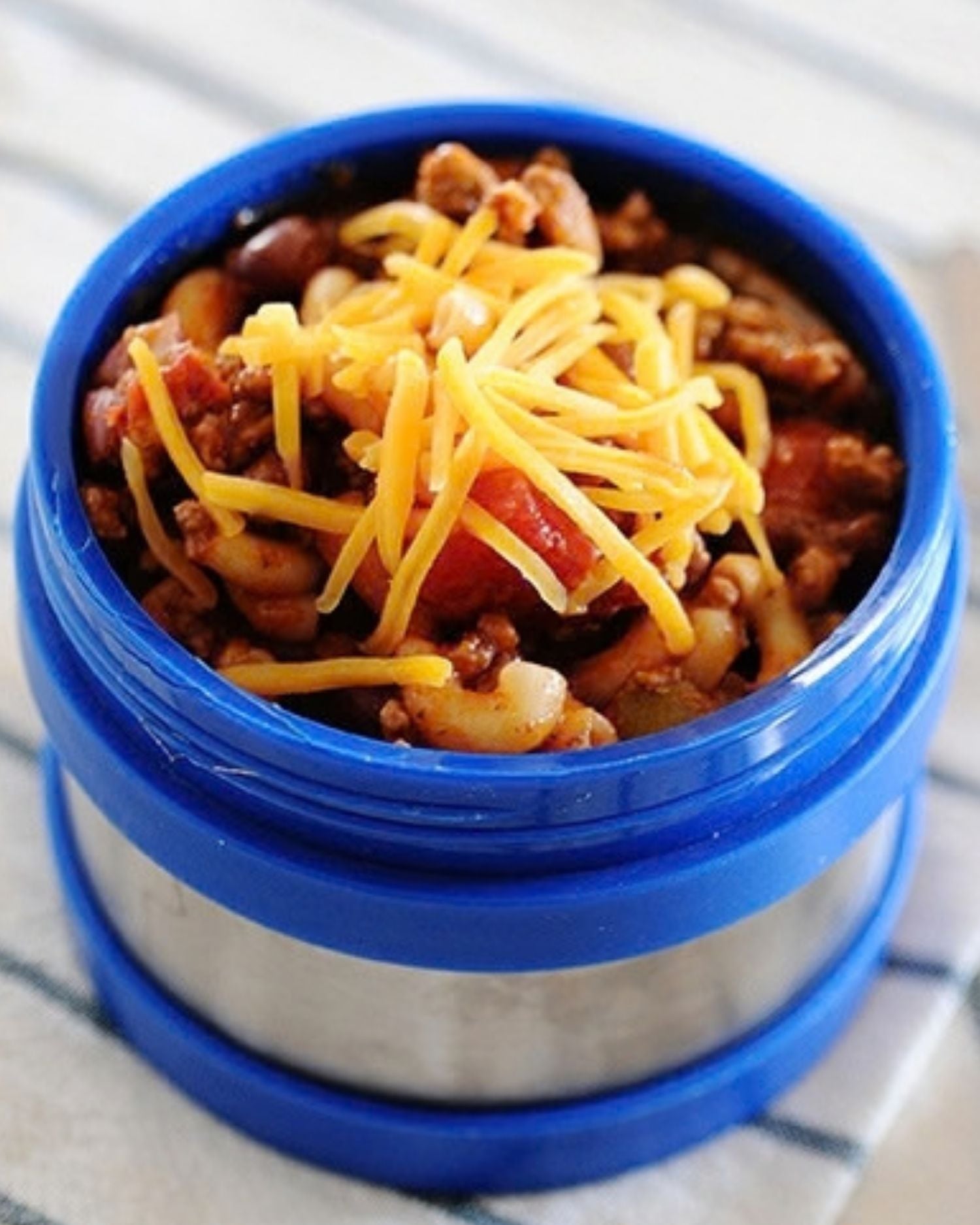 chili mac topped with cheese in a thermos