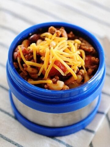 chili mac topped with cheese in a thermos