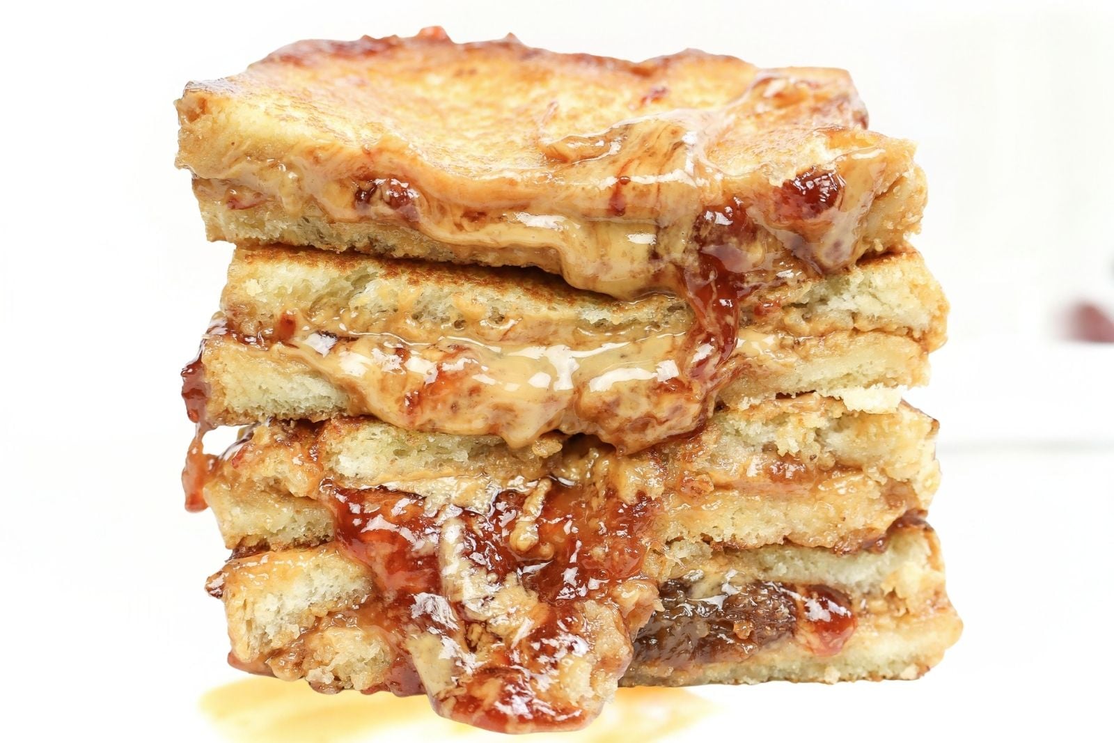 Grilled pb & j sandwich sliced in half and stacked.