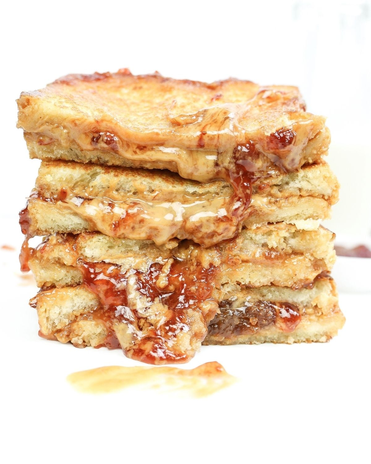 Grilled pb & j sandwich sliced in half and stacked.