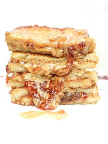Grilled pb & j sandwich sliced in half and stacked.