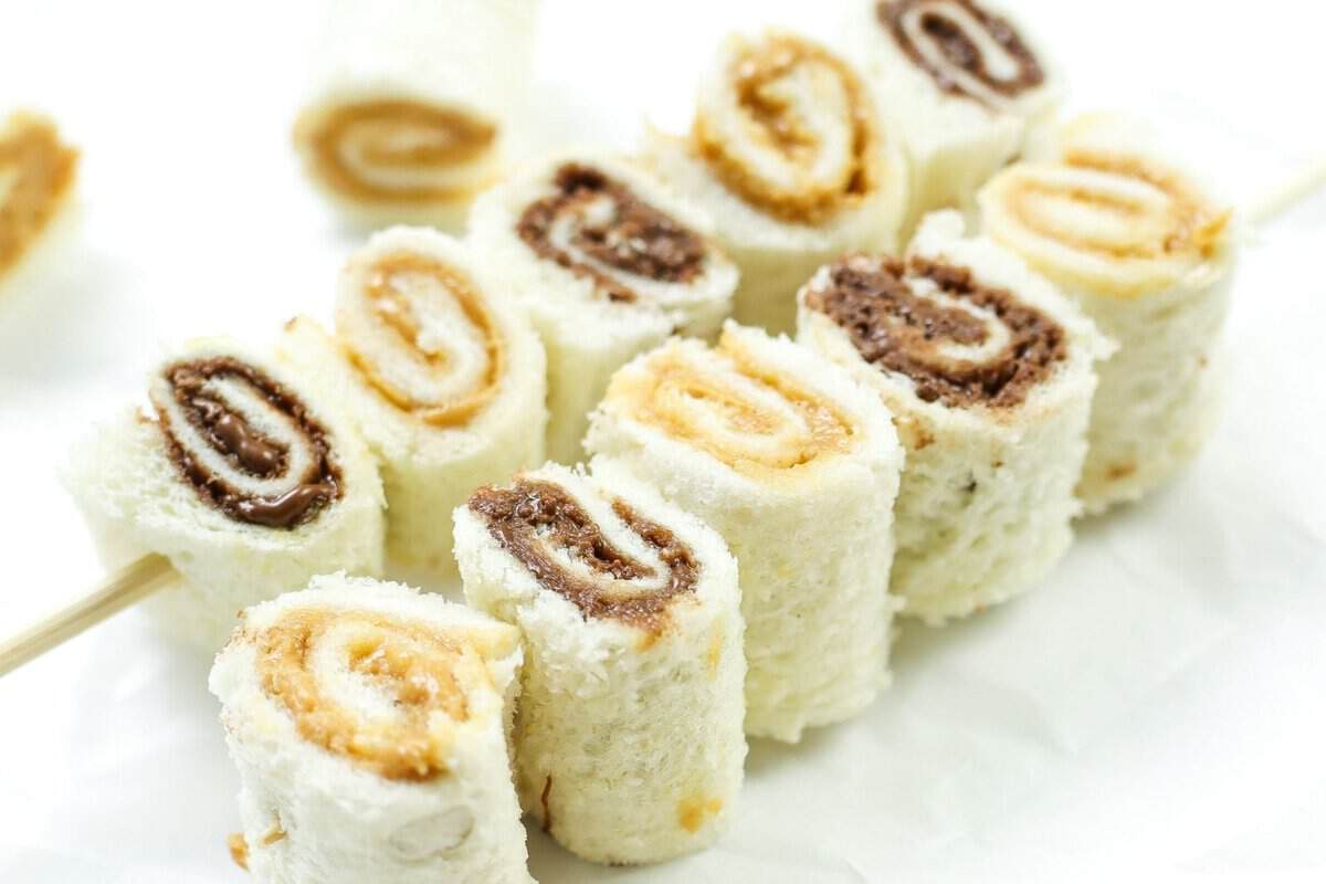 two skewers of sandwich rolls with peanut butter and nutella