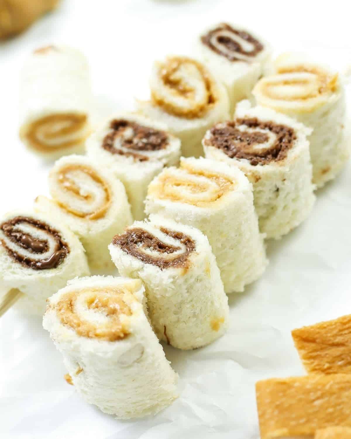 two skewers of sandwich rolls with peanut butter and nutella