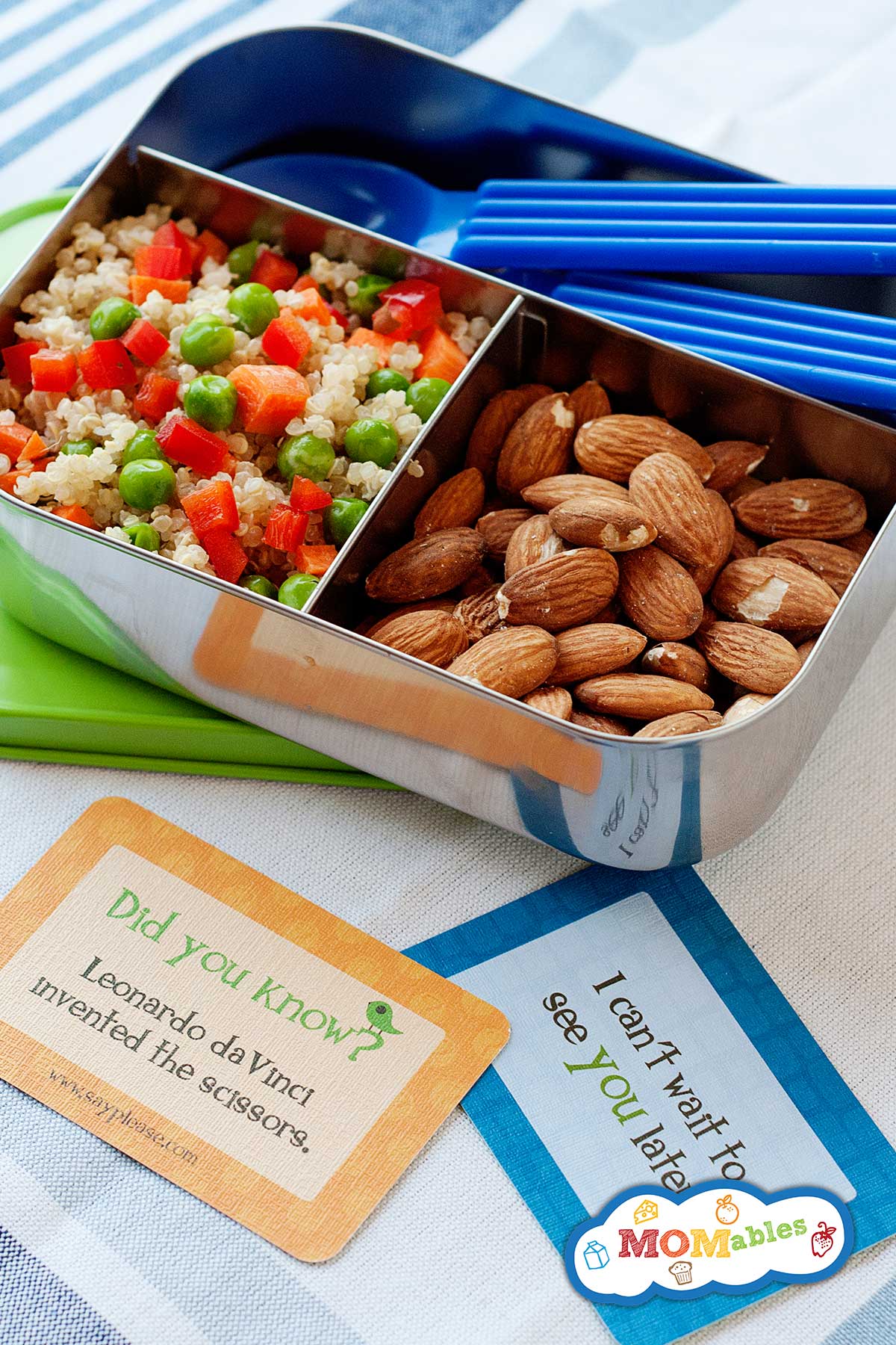 small metal lunch container filled with quinoa salad and almonds. Two lunch note cards with the lunch
