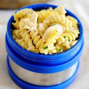 salsa verde chicken pasta in a blue thermos lunch container