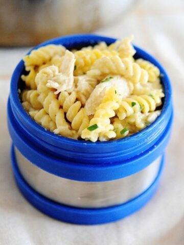 salsa verde chicken pasta in a blue thermos lunch container