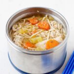 A thermos filled with homemade chicken noodle soup