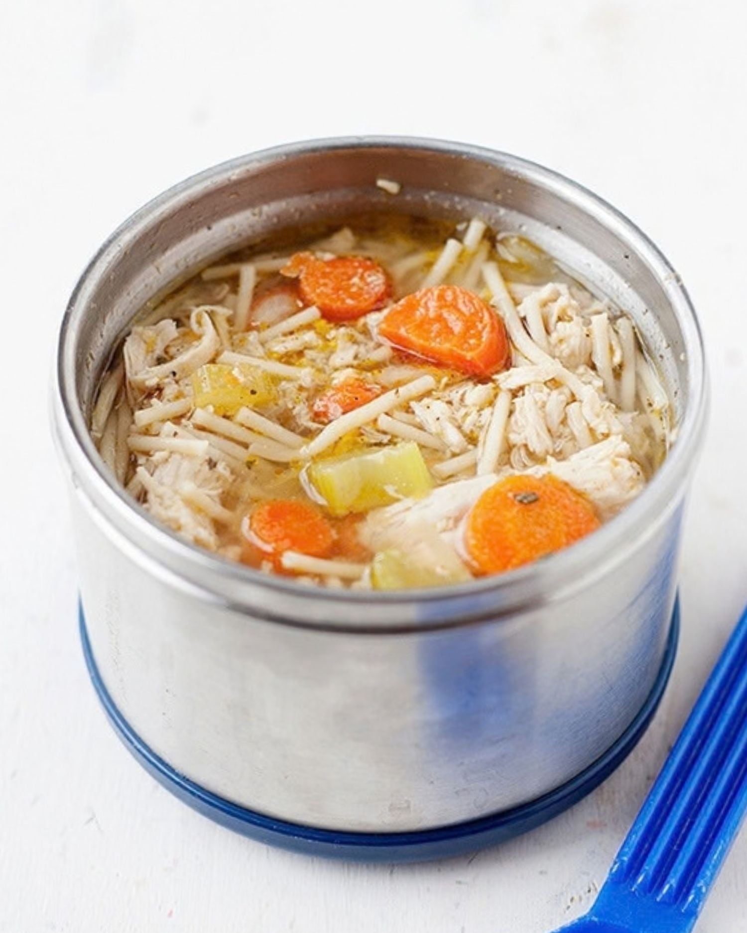 A thermos filled with homemade chicken noodle soup