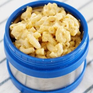 blue lunch thermos filled with macaroni and cheese
