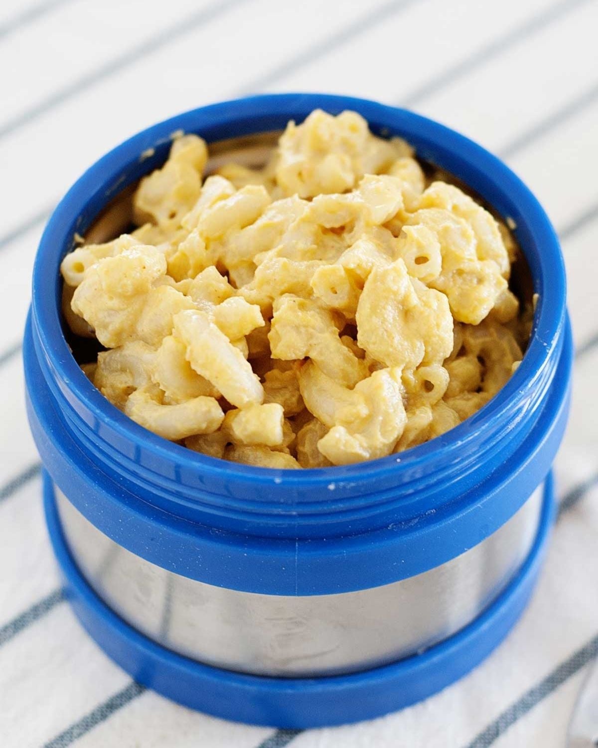 blue lunch thermos filled with macaroni and cheese