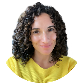 Laura Fuentes, founder of MOMables wearing a yellow shirt and looking at the camera smiling