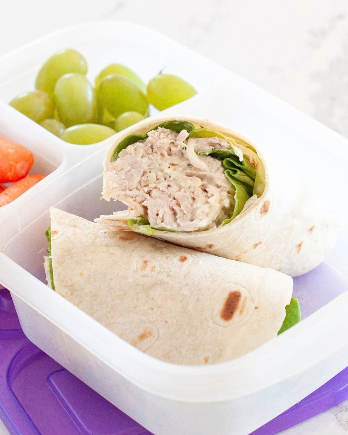 close up of a chicken caesar wrap inside a lunch box