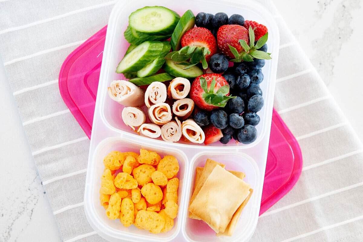 fruits and veggies and turkey inside a lunch container