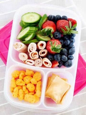 fruits and veggies and turkey inside a lunch container