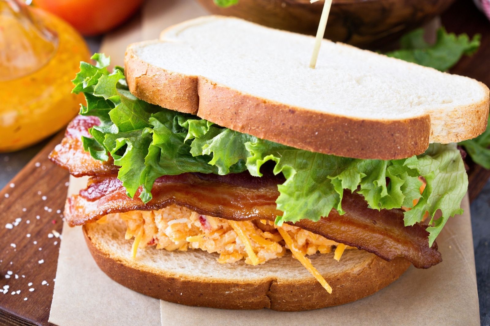 pimento cheese btl sandwich on a wooden board