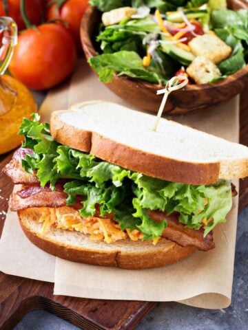 pimento cheese btl sandwich on a wooden board