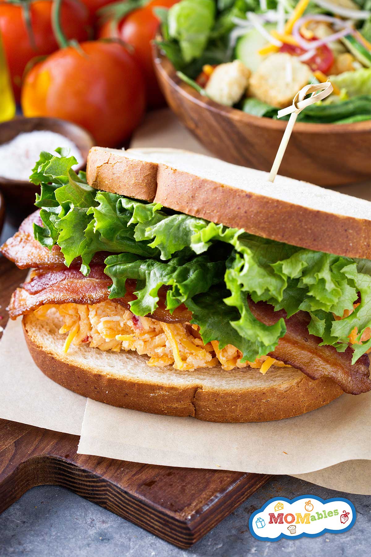 pimento cheese btl sandwich on a wooden board
