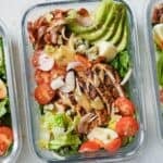 overhead view of a glass lunchbox with cobb salad