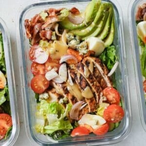overhead view of a glass lunchbox with cobb salad