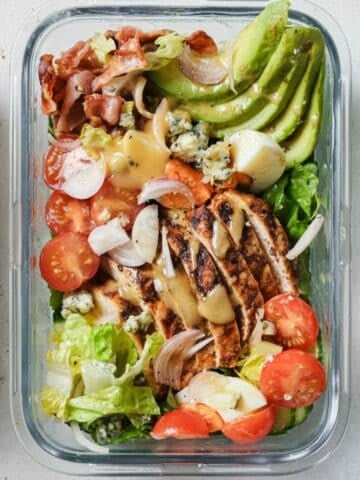 overhead view of a glass lunchbox with cobb salad