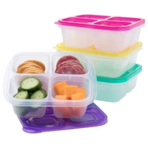 3 bento snack boxes stacked and one filled with food
