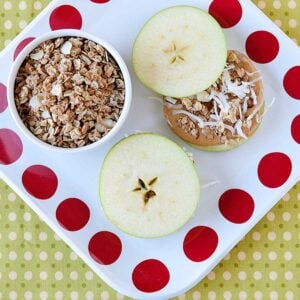 a tray with two apple sandwiches an a bowl of granola