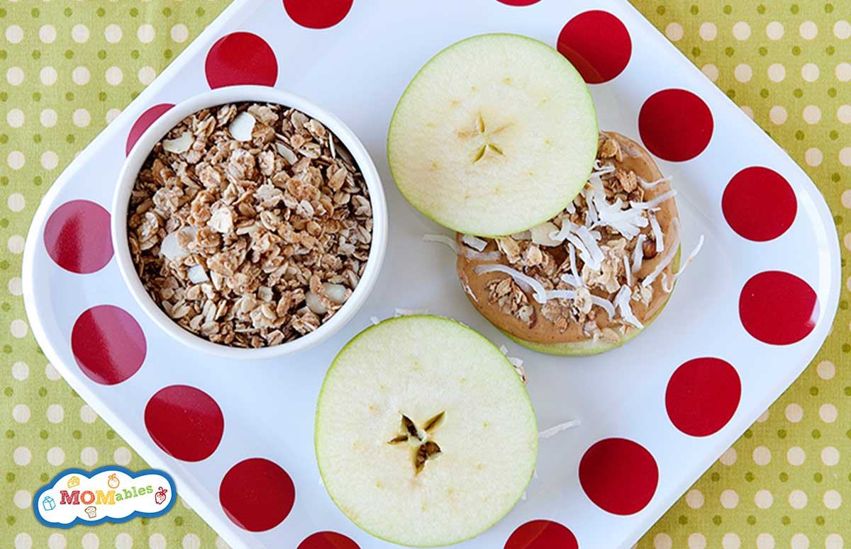 a tray with two apple sandwiches an a bowl of granola