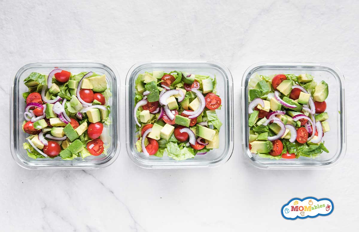 three lunchboxes with tomato avocado salad