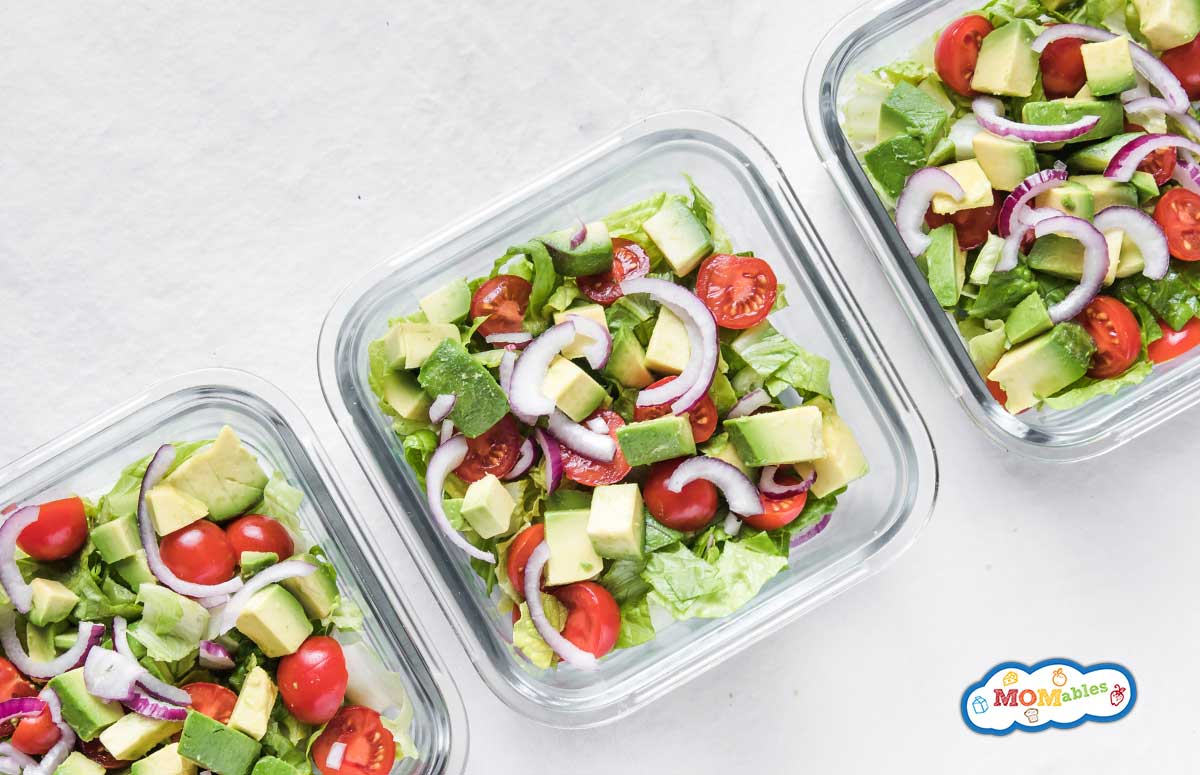 three lunchboxes with tomato avocado salad
