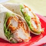 crispy chicken wrap sliced in half on a plate