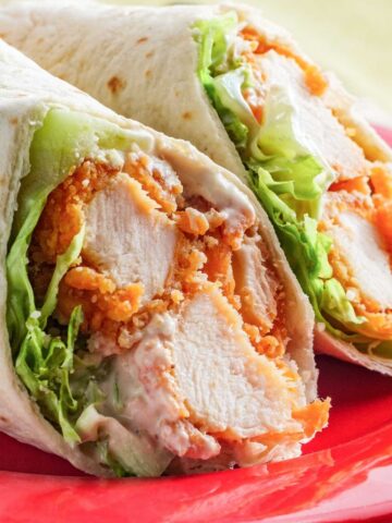 crispy chicken wrap sliced in half on a plate